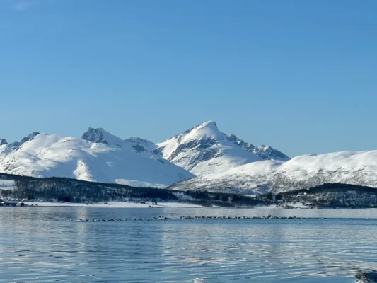 Snow-covered Kvaløya mountains on a sunny winter day near Tromsø
