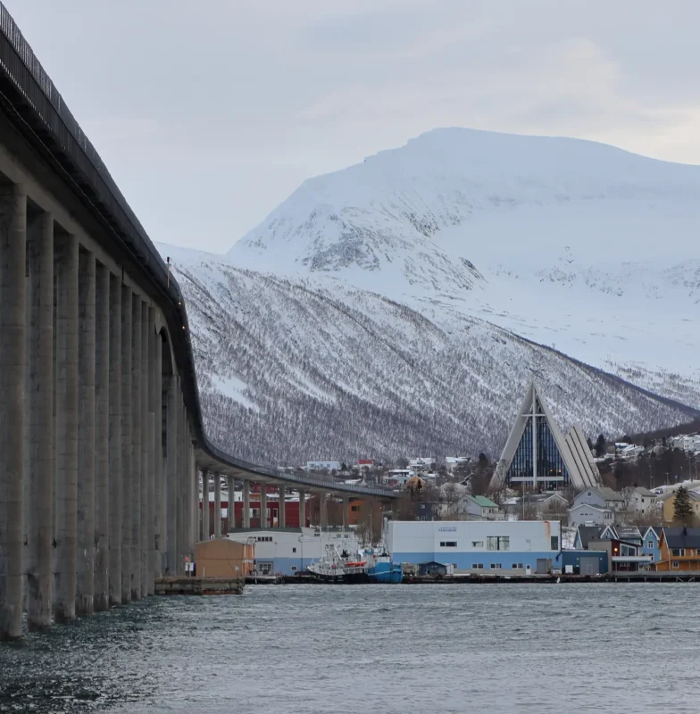 Tromsø Bridge and Arctic Cathedral with snowy mountains in winter
