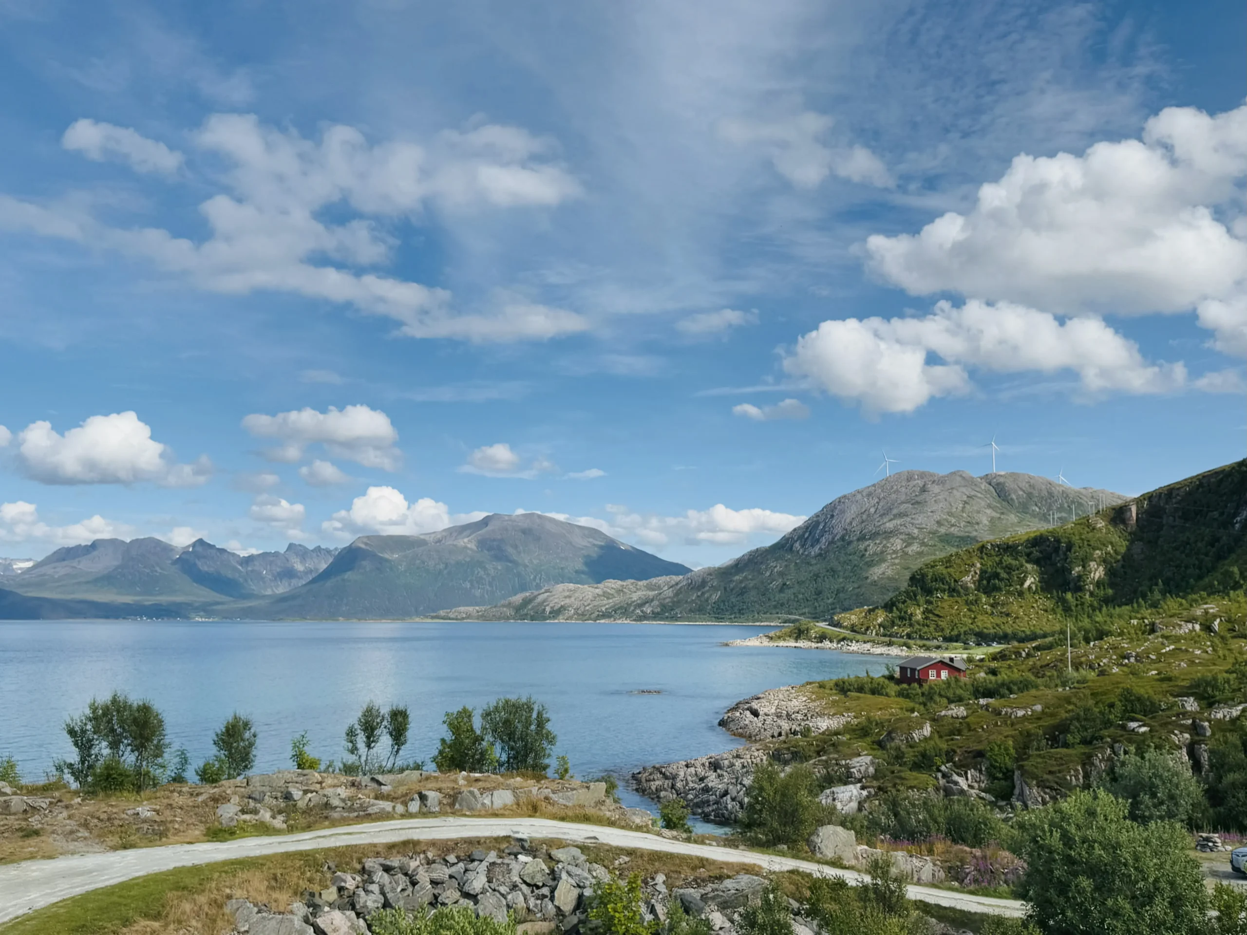 Panoramic view of Arctic fjord and mountains with a red cabin near Sommarøy, Tromsø, Norway.